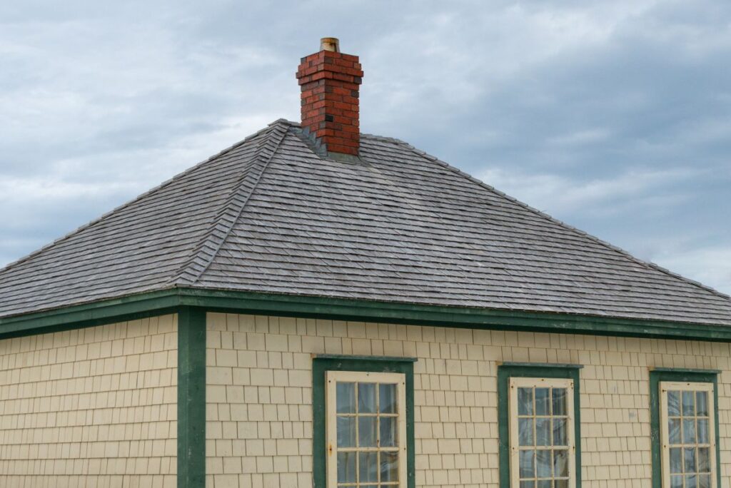 pitched roof yellow sliding green frame windows