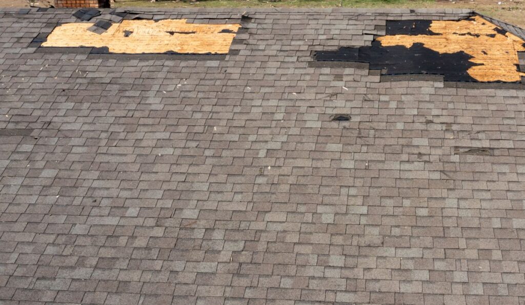 wind damage roof repair shingles missing on big roof