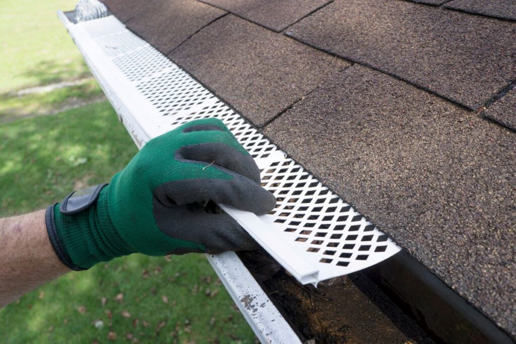 Contractor Adjusting Plastic Gutter Guardsv
