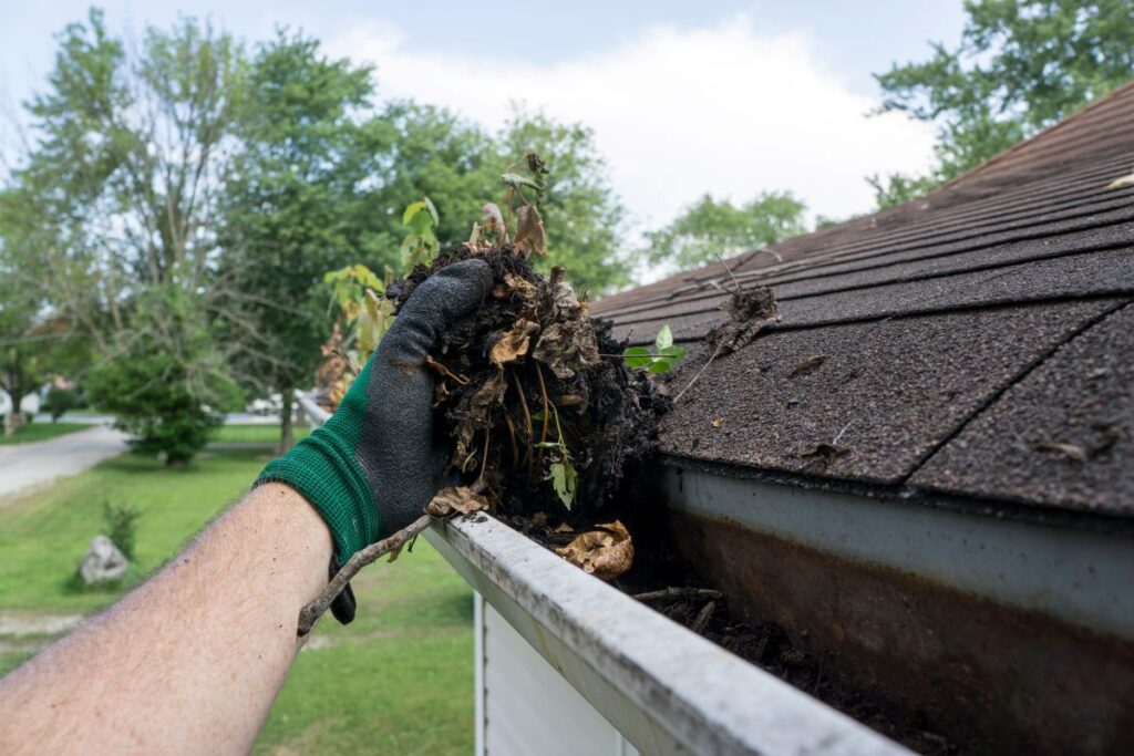 all seasons roofing glove holding debris