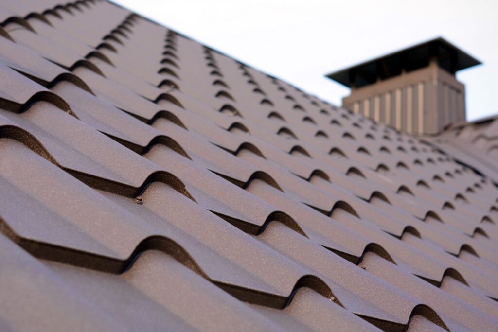 New brown metal tile roof and chimney.