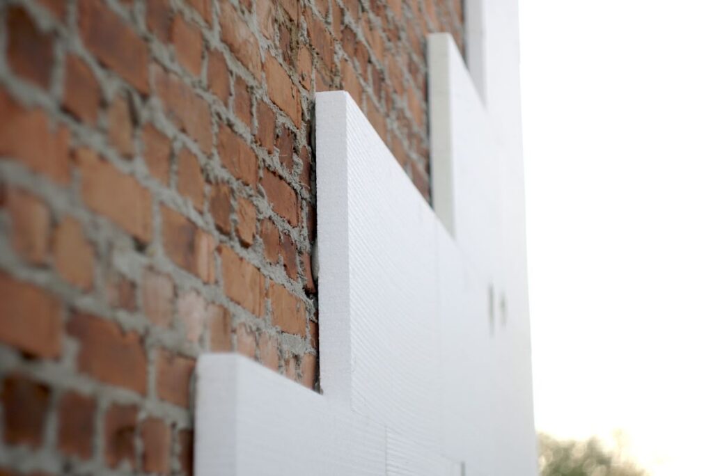 insulation of a brick wall with polystyrene white
