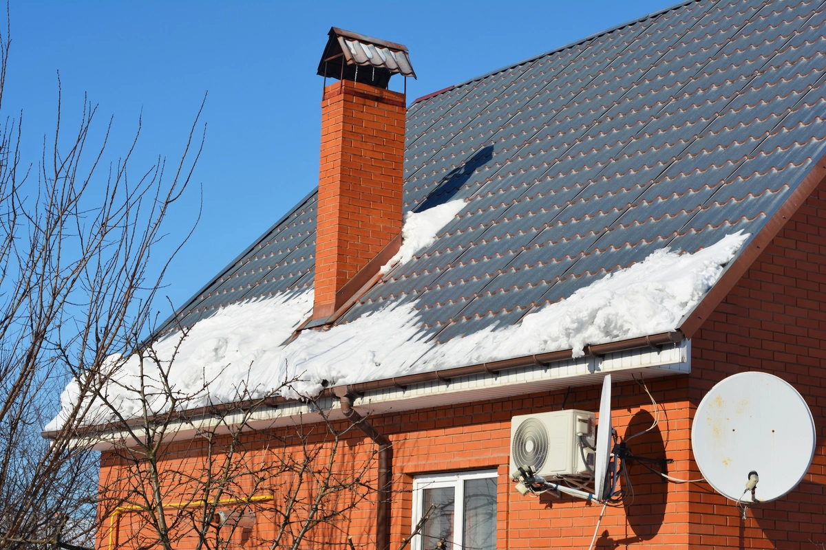 Melting Snow on House Roof Threatens Gutter