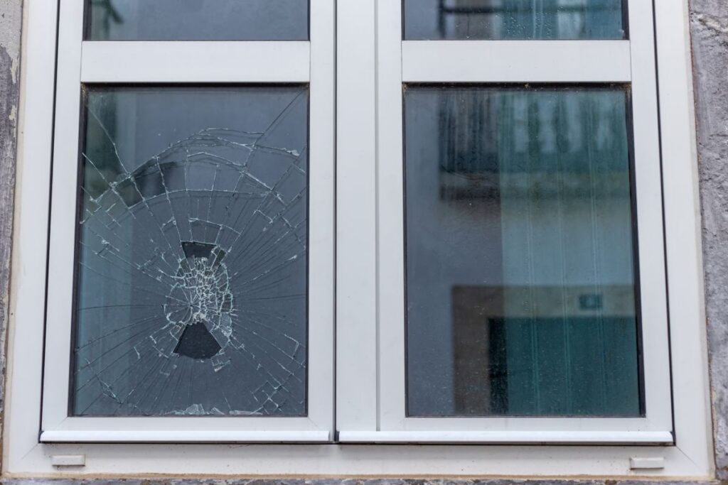 Cracked glass in a plastic vacuum window frame