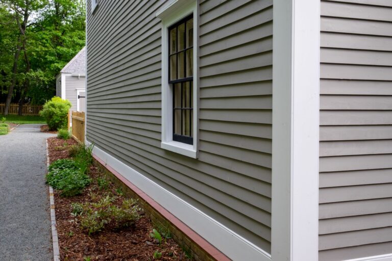 James Hardie siding, tan colored house with white trim and black wood window frame spacers